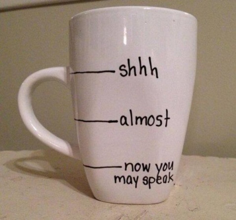 A white mug marked shhh, almost, now you may speak