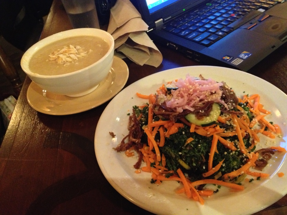 Curried cauliflower soup and winter Caesar salad on a restaurant table