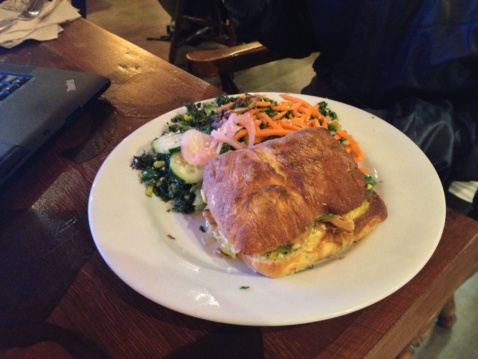 A ciabatta sandwich and salad on a restaurant table