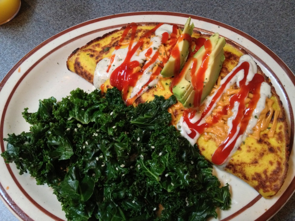 Omelet and kale on a round plate