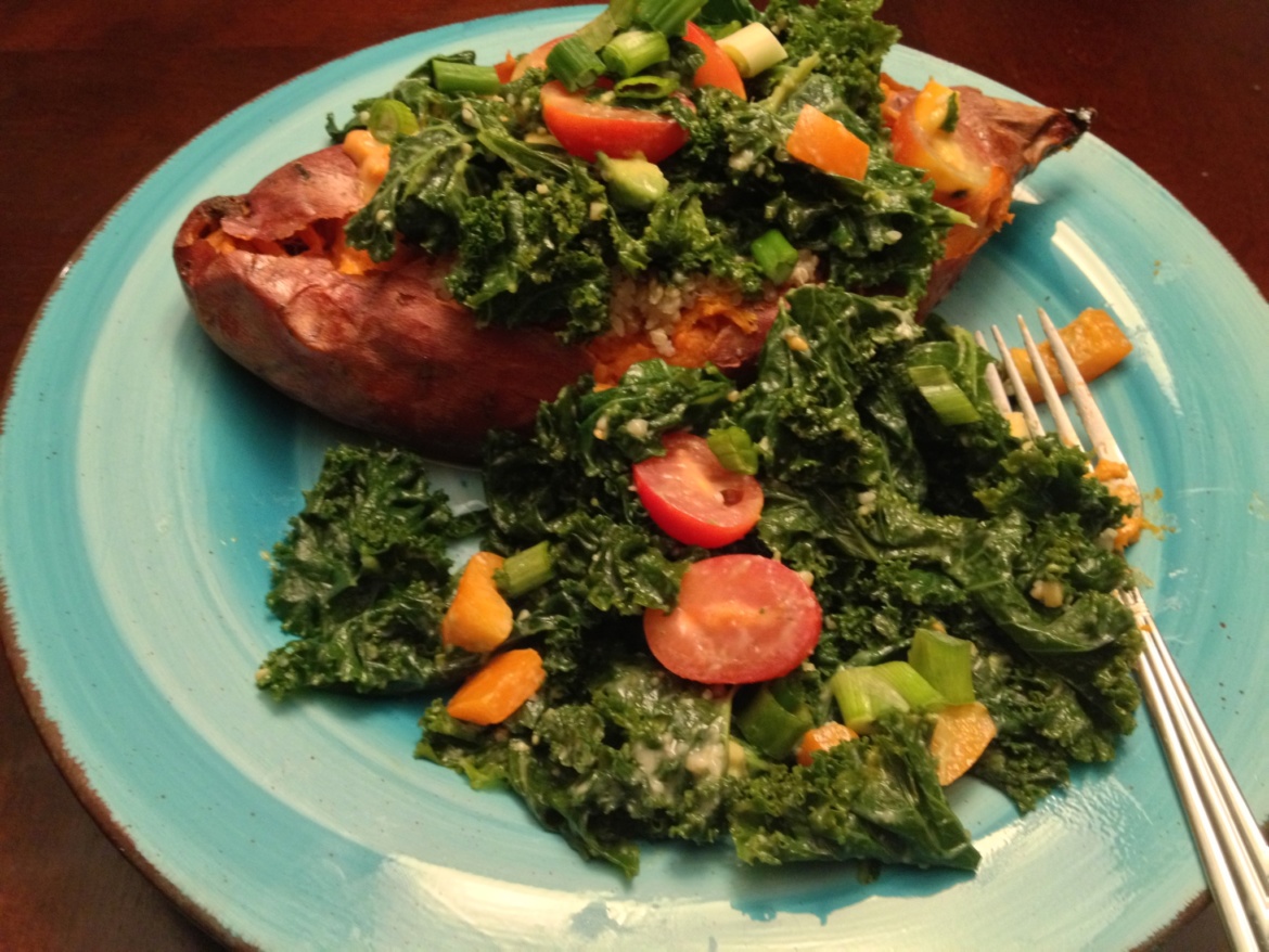 Baked sweet potato with vegetables on a light blue plate