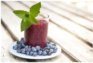 A blueberry breakfast smoothie in a glass