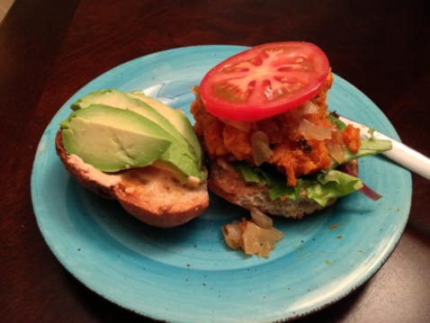 A roasted sweet potato and caramelized onion sandwich on a light blue plate