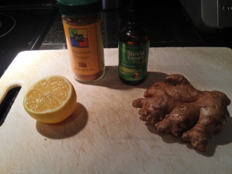 Cayenne pepper, stevia extract, lemon, and ginger on a cutting board