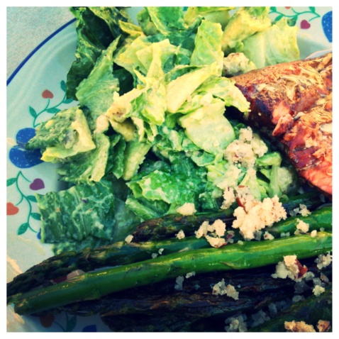 Grilled fish, vegan Caesar salad, and asparagus on a plate