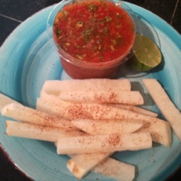 Jicama fries with a side of salsa on a light blue plate
