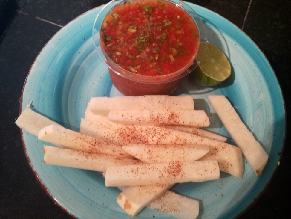 Jicama fries with a side of salsa on a light blue plate