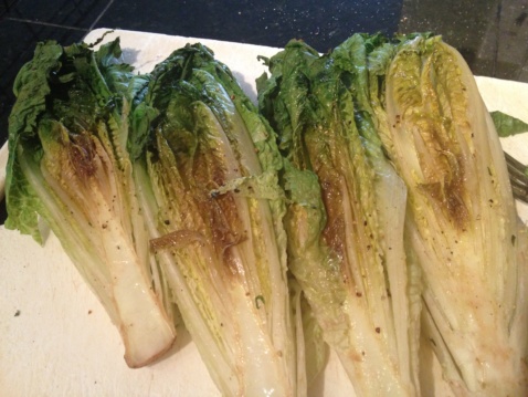 Grilled romaine lettuce on a cutting board