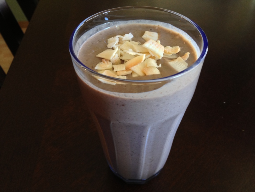 A purple protein hemp milkshake in a tall glass