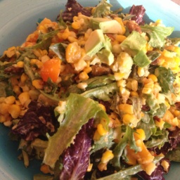 Summer salad of roasted peach, poblano and corn on a light blue plate