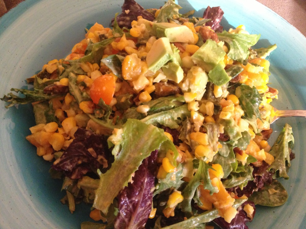 Summer salad of roasted peach, poblano and corn on a light blue plate