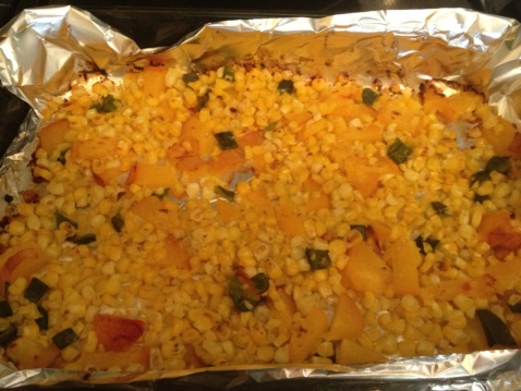 Peaches, poblano pepper and corn on a baking tray