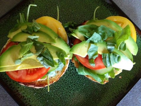 Two summer sandwiches with whole-grain bread, tomato, cucumber, avocado, and Vegenaise