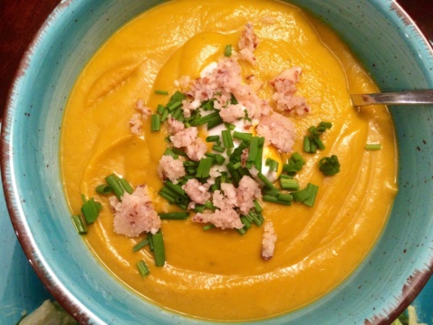 Creamy acorn squash soup in a light blue bowl