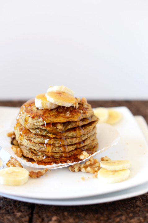Banana pancakes with syrup on a white plate