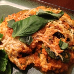 Eggplant lasagna and greens on a plate