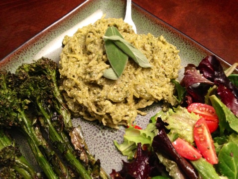 Squash spaghetti with pesto and greens on a plate