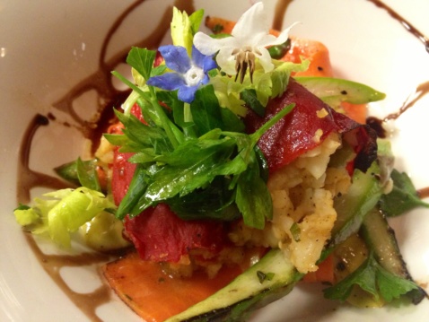 A green salad with flowers on top