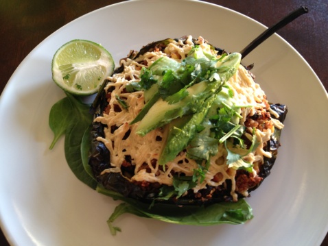 A vegan Chile Relleno pepper topped with vegan cheese and avocado