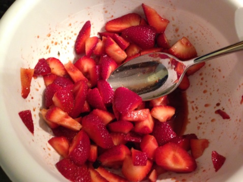 Chopped strawberries in a white bowl