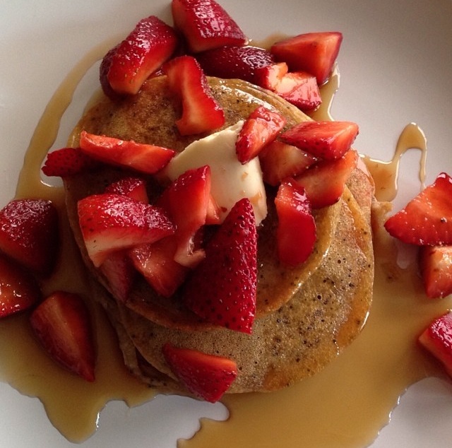 Pancakes with syrup and strawberries on a plate