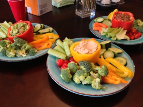 Three light blue plates with dips and different vegetables