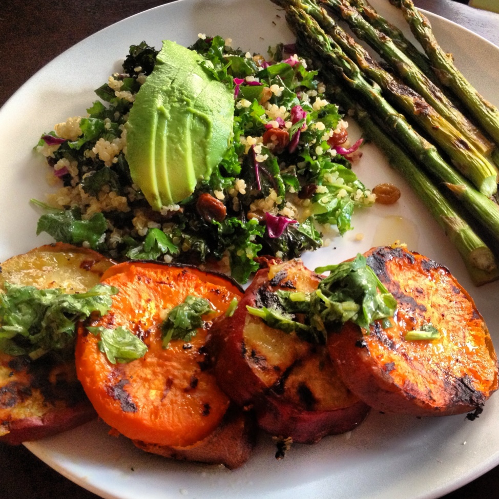 Grilled sweet potatoes, asparagus, and a green salad on a plate