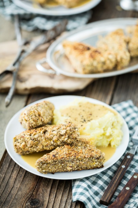 Maple Hazelnut Crusted Tempeh Cutlets on plates on a wooden table