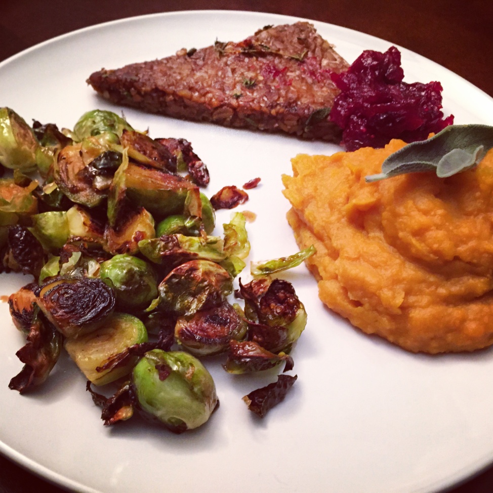 Sweet potato mash and roasted artichokes on a white plate