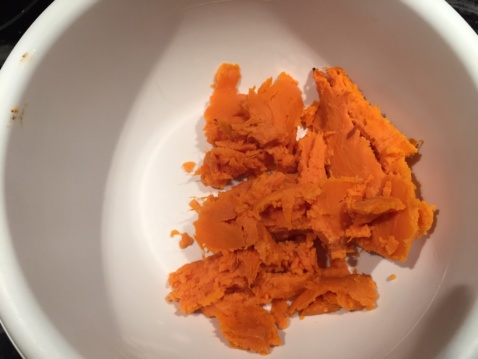 Scooped sweet potato flesh in a white bowl