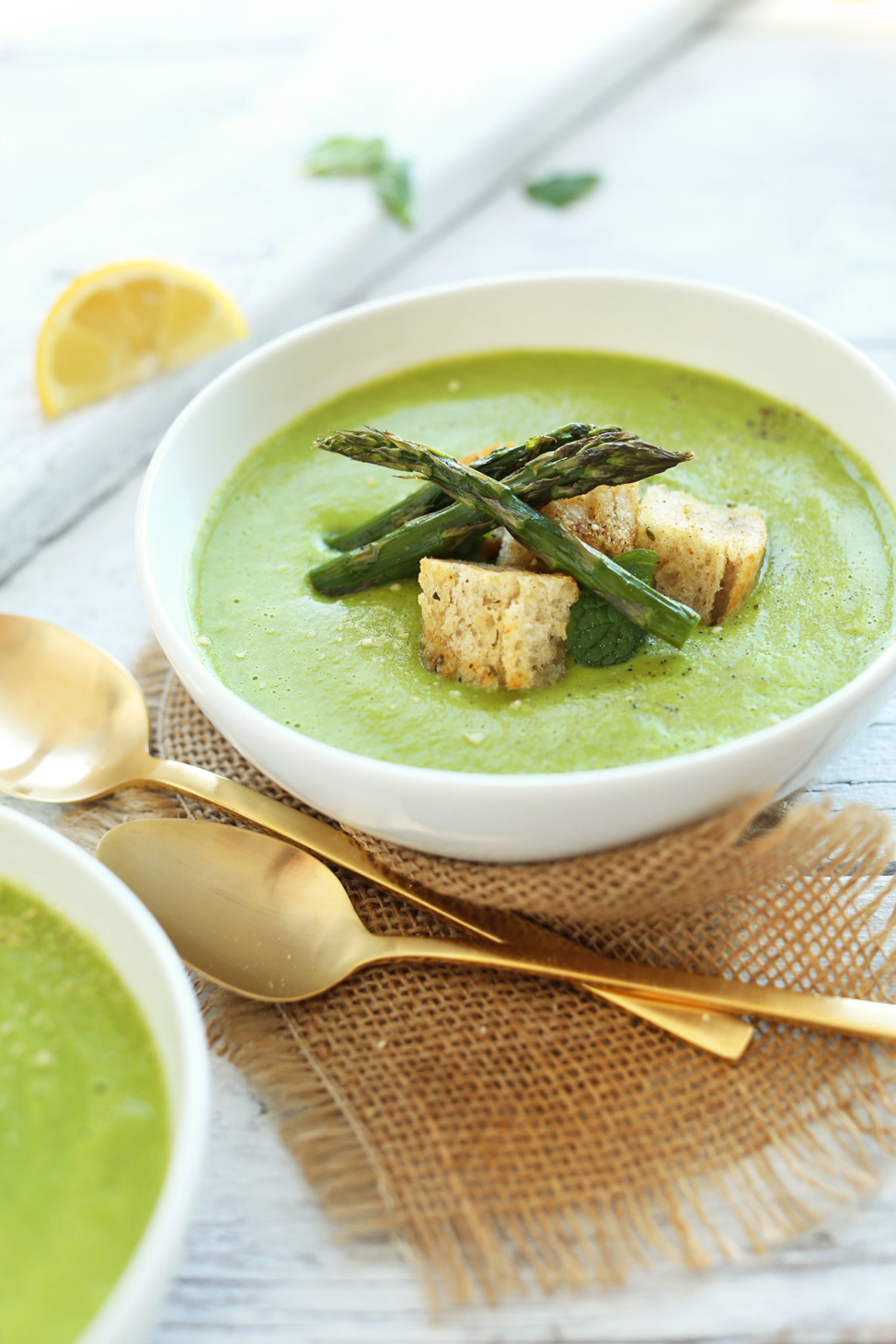 Creamy asparagus and pea soup topped with asparagus and croutons
