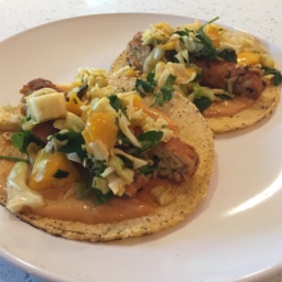 Two grilled tempeh tacos on a plate