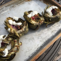 Grilled artichokes with aioli on a tray