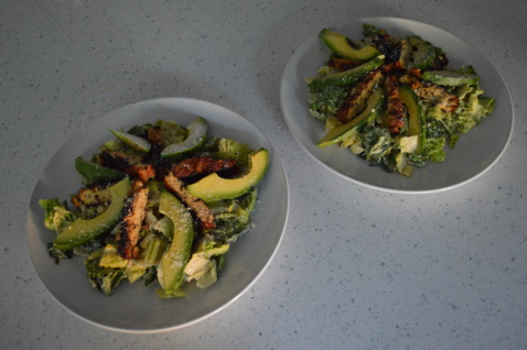 Two plates of Blackened tempeh Caesar salad with avocado