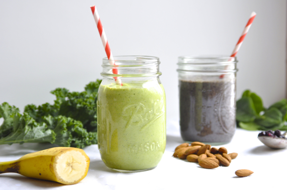 Two green smoothies on a white surface