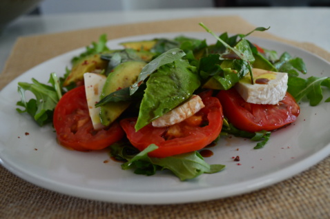 Vegan Avocado Caprese Salad with tomatoes, greens, and vegan cheese