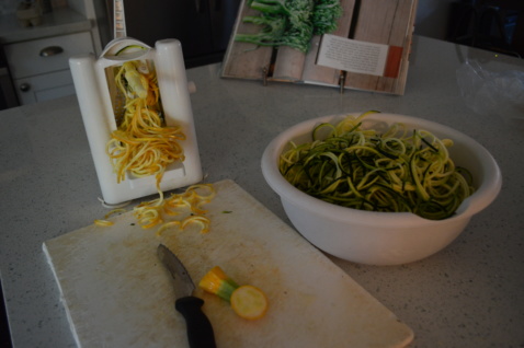 Zucchini going through a spiralizer