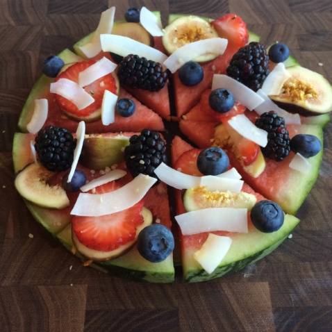 Watermelon pizza with blackberries, figs, strawberries, and coconut flakes
