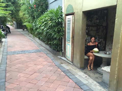 Lauren having fresh coconut water at a restaurant terrace