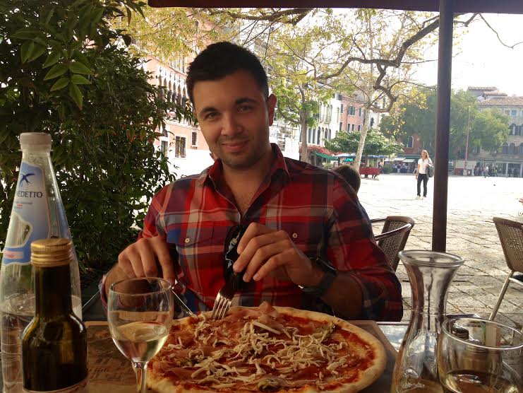 Lauren's husband enjoying pizza in Italy
