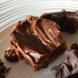 A piece of Dark Chocolate Peanut Butter Fudge on a white plate