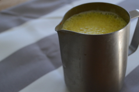 Turmeric milk in a metal pitcher