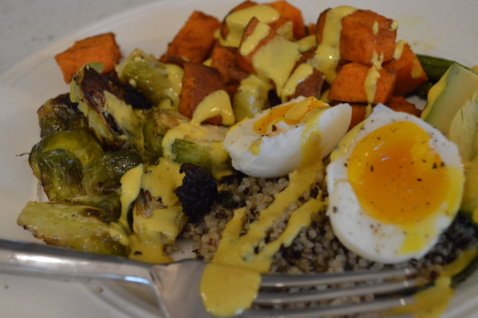 A grain bowl with quinoa, Brussels sprouts, sweet potatoes and a boiled egg