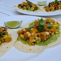 Two summer squash & corn tacos with avocado cilantro crema
