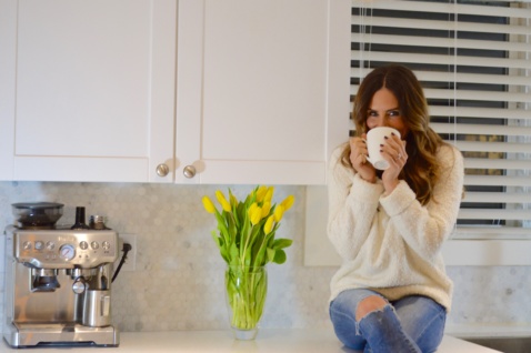 Lauren having the bulletproof coffee in her kitchen